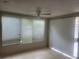 Bright living room with tiled floors and two windows and sliding glass doors provide plenty of natural light at 5125 Puritan Cir # 1103, Tampa, FL 33617