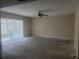Neutral living room showing fan, patio access, and white walls at 5125 Puritan Cir # 1103, Tampa, FL 33617