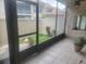 View of the home's patio looking out to the yard with green space and planters at 5125 Puritan Cir # 1103, Tampa, FL 33617