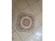Close-up of the decorative tile flooring, featuring a unique motif in tan and brown tones at 5125 Puritan Cir # 1103, Tampa, FL 33617