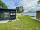 Backyard includes a lawn, fence, screened in porch, and shed at 7026 20Th N St, St Petersburg, FL 33702