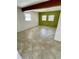 Spacious bedroom with neutral-toned tile flooring and a wall painted in a vibrant accent color at 7026 20Th N St, St Petersburg, FL 33702