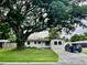 Charming single-story home with a large shade tree on the front lawn and ample space for parking at 7026 20Th N St, St Petersburg, FL 33702