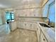 A newly remodeled kitchen features white cabinets and stone countertops at 7026 20Th N St, St Petersburg, FL 33702