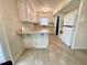 A bright kitchen featuring white cabinets, white appliances, and a breakfast bar at 7026 20Th N St, St Petersburg, FL 33702