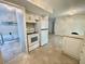 Bright kitchen with an electric range oven, a white refrigerator and tile flooring at 7026 20Th N St, St Petersburg, FL 33702