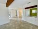 Open-concept living space with tile flooring and a decorative ceiling beam at 7026 20Th N St, St Petersburg, FL 33702
