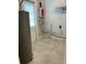 Utility room featuring tile floors, a water heater, and access to the outside at 7026 20Th N St, St Petersburg, FL 33702