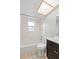 Clean bathroom highlighting a shower-tub combination, white tiled walls, and neutral-colored vanity with modern fixtures at 7108 14Th Nw Ave, Bradenton, FL 34209