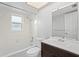 Bright bathroom featuring white tile, a shower-tub combination, and a vanity with dark wood cabinets at 7108 14Th Nw Ave, Bradenton, FL 34209