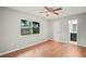 Bright bedroom with wood floors, ceiling fan, and window views of the backyard at 7108 14Th Nw Ave, Bradenton, FL 34209