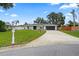 Inviting single-story home with a lush green lawn, featuring mature trees and a well-manicured landscape at 7108 14Th Nw Ave, Bradenton, FL 34209