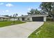 Charming single-story home with a well-maintained lawn and a long driveway leading to a two-car garage at 7108 14Th Nw Ave, Bradenton, FL 34209