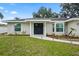 Close-up of the front entrance highlighting the double front doors and freshly landscaped garden beds at 7108 14Th Nw Ave, Bradenton, FL 34209