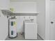 The laundry room features a washing machine and a water heater with shelving for storage at 7108 14Th Nw Ave, Bradenton, FL 34209