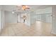 Open concept living room with tile floors, ceiling fan, and views of the kitchen and front door at 7108 14Th Nw Ave, Bradenton, FL 34209