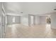 Expansive living room boasts neutral walls, tile flooring, and multiple openings to other living spaces at 7108 14Th Nw Ave, Bradenton, FL 34209