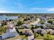 Wide aerial view of a residential area with lake access and lush greenery at 7619 Limington Dr, Port Richey, FL 34668