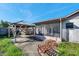Backyard featuring a screened lanai, a wooden gazebo, and an outdoor seating area at 7619 Limington Dr, Port Richey, FL 34668