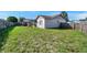 Fenced backyard with a wooden gazebo, a screened in porch, and a grassy lawn at 7619 Limington Dr, Port Richey, FL 34668
