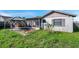 Backyard features a screened-in lanai, a wooden gazebo, and a grassy yard at 7619 Limington Dr, Port Richey, FL 34668