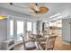 Charming dining area with modern ceiling fan and adjacent white kitchen at 7619 Limington Dr, Port Richey, FL 34668