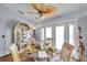 Sunlit dining nook with stylish furnishings and a view into adjacent rooms at 7619 Limington Dr, Port Richey, FL 34668