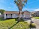 Charming single-story home featuring a palm tree in the front yard and a one car garage at 7619 Limington Dr, Port Richey, FL 34668