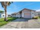 Single-story home with attached garage and a paved driveway, set against a clear blue sky at 7619 Limington Dr, Port Richey, FL 34668