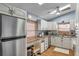 Efficient kitchen with stainless steel appliances, white cabinets, and breakfast nook at 7619 Limington Dr, Port Richey, FL 34668