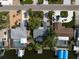 Aerial view of the waterfront property with pool, boat dock, and lush landscaping at 911 Sago Palm Way Way, Apollo Beach, FL 33572