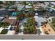 Aerial view of a single-story home on a waterfront property with mature trees at 911 Sago Palm Way Way, Apollo Beach, FL 33572