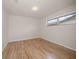 Bedroom featuring wood-look flooring, bright white walls, and a window at 911 Sago Palm Way Way, Apollo Beach, FL 33572