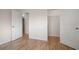 Bright bedroom featuring wood-look floors, white walls and a walk-in closet at 911 Sago Palm Way Way, Apollo Beach, FL 33572
