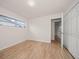 Bedroom featuring wood-look flooring, bright white walls, and a closet at 911 Sago Palm Way Way, Apollo Beach, FL 33572
