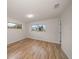 Bedroom featuring wood-look flooring, bright white walls, and two windows at 911 Sago Palm Way Way, Apollo Beach, FL 33572