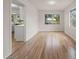 Light and airy dining room with wood floors, adjacent to kitchen, offering ample natural light at 911 Sago Palm Way Way, Apollo Beach, FL 33572