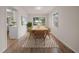 Bright dining room featuring a wooden table, six chairs, and a large window offering ample natural light at 911 Sago Palm Way Way, Apollo Beach, FL 33572