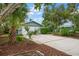 Charming home exterior featuring a well-maintained lawn, mature landscaping, and a two-car garage at 911 Sago Palm Way Way, Apollo Beach, FL 33572