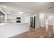 Modern kitchen with white cabinets, stainless steel appliances, and a spacious island with quartz countertop at 911 Sago Palm Way Way, Apollo Beach, FL 33572