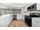 Modern kitchen features a large window with views of the water, stainless steel appliances and ample cabinet space at 911 Sago Palm Way Way, Apollo Beach, FL 33572