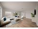 Bright and airy living room with hardwood floors, modern furnishings, and ample natural light at 911 Sago Palm Way Way, Apollo Beach, FL 33572
