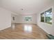Bright living room with beautiful wood floors and views of the outdoors from every window at 911 Sago Palm Way Way, Apollo Beach, FL 33572