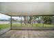 Enclosed patio overlooking a tranquil canal and lush greenery, perfect for outdoor relaxation at 911 Sago Palm Way Way, Apollo Beach, FL 33572