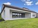 Rear exterior view of a home featuring a covered patio and expansive lawn at 15003 Rider Pass Dr, Lithia, FL 33547