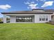 A well-manicured backyard with large sliding glass doors and ample space for outdoor activities at 15003 Rider Pass Dr, Lithia, FL 33547