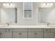 Bathroom featuring a double vanity with modern hardware and updated lighting at 15003 Rider Pass Dr, Lithia, FL 33547
