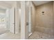 New bathroom featuring a stylish tiled shower with built-in bench at 15003 Rider Pass Dr, Lithia, FL 33547