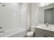 Bright bathroom with a white tub and a gray vanity, offering a functional and stylish space for personal care routines at 15003 Rider Pass Dr, Lithia, FL 33547