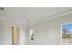 Light bedroom with trim and crown molding details, showing multiple windows at 15003 Rider Pass Dr, Lithia, FL 33547